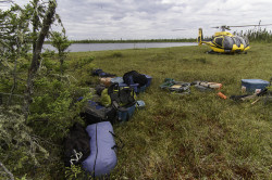 Unloading camp gear from a helicopter in Ontario's Far north muskeg