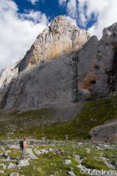 woman staring up at sheer valley walls near Mt MacDonald Yukon