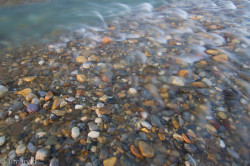 clear water flowing over colourful river stones, snake river, Yukon