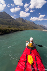 Red canoe in a mountain river